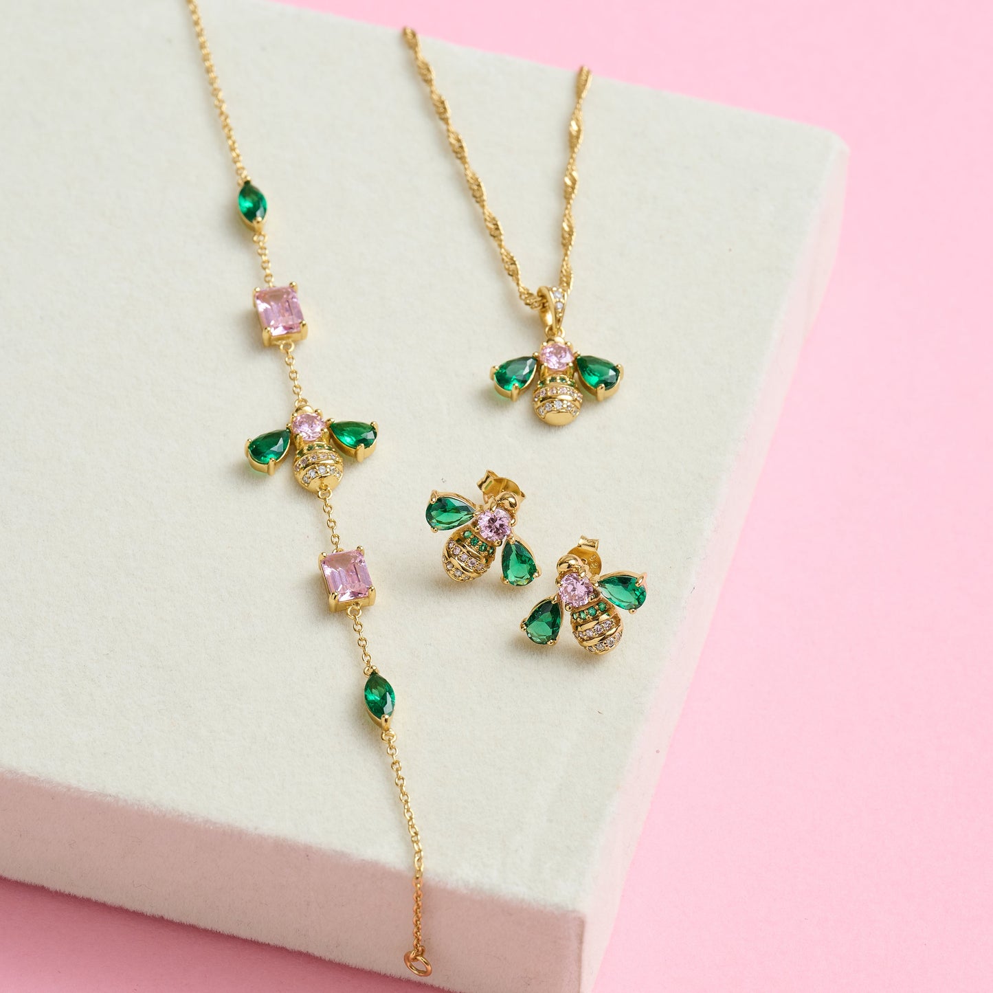 Beatrice Jewelled Bee Collection emerald and blush pink gold bee necklace, bracelet, and earrings set on white display box