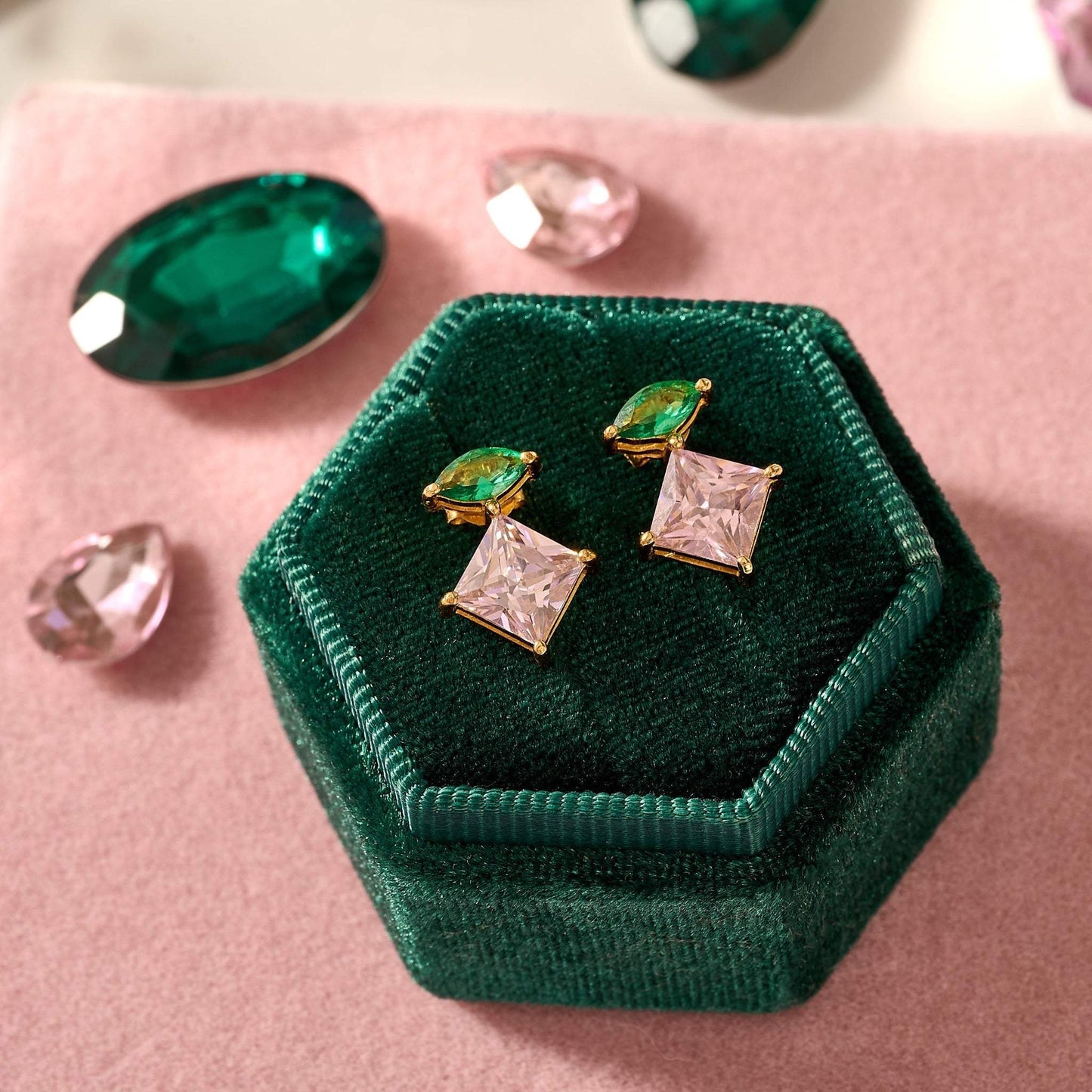 Unusual gold earrings. Amelia Scott emerald green and pink cubic zirconia stud earrings with 18k gold plating on green velvet box