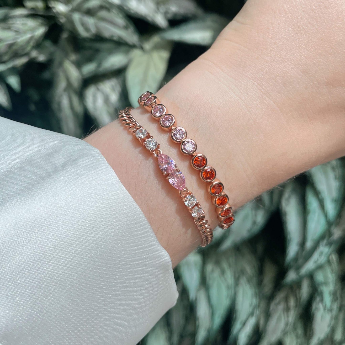 Rose Gold Tennis Bracelet Pink & Orange stacked on the wrist with other bracelets