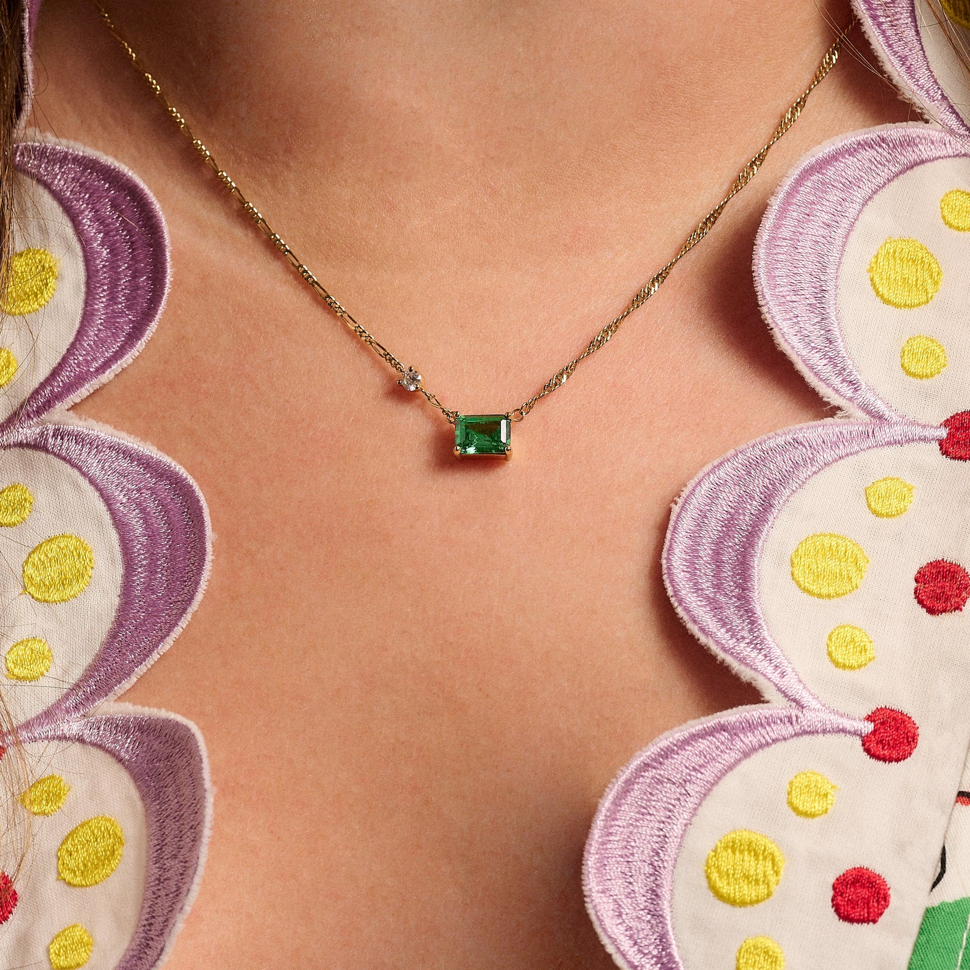 Lola emerald cut necklace, emerald green and gold chain on necklace styled on model