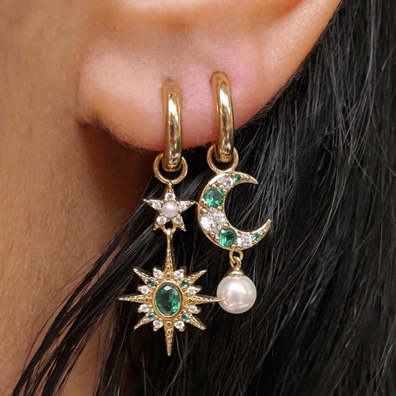 Moon & Star Huggie Hoop Earrings with asymmetric moon and star charms featuring emerald green cubic zirconia and faux pearls