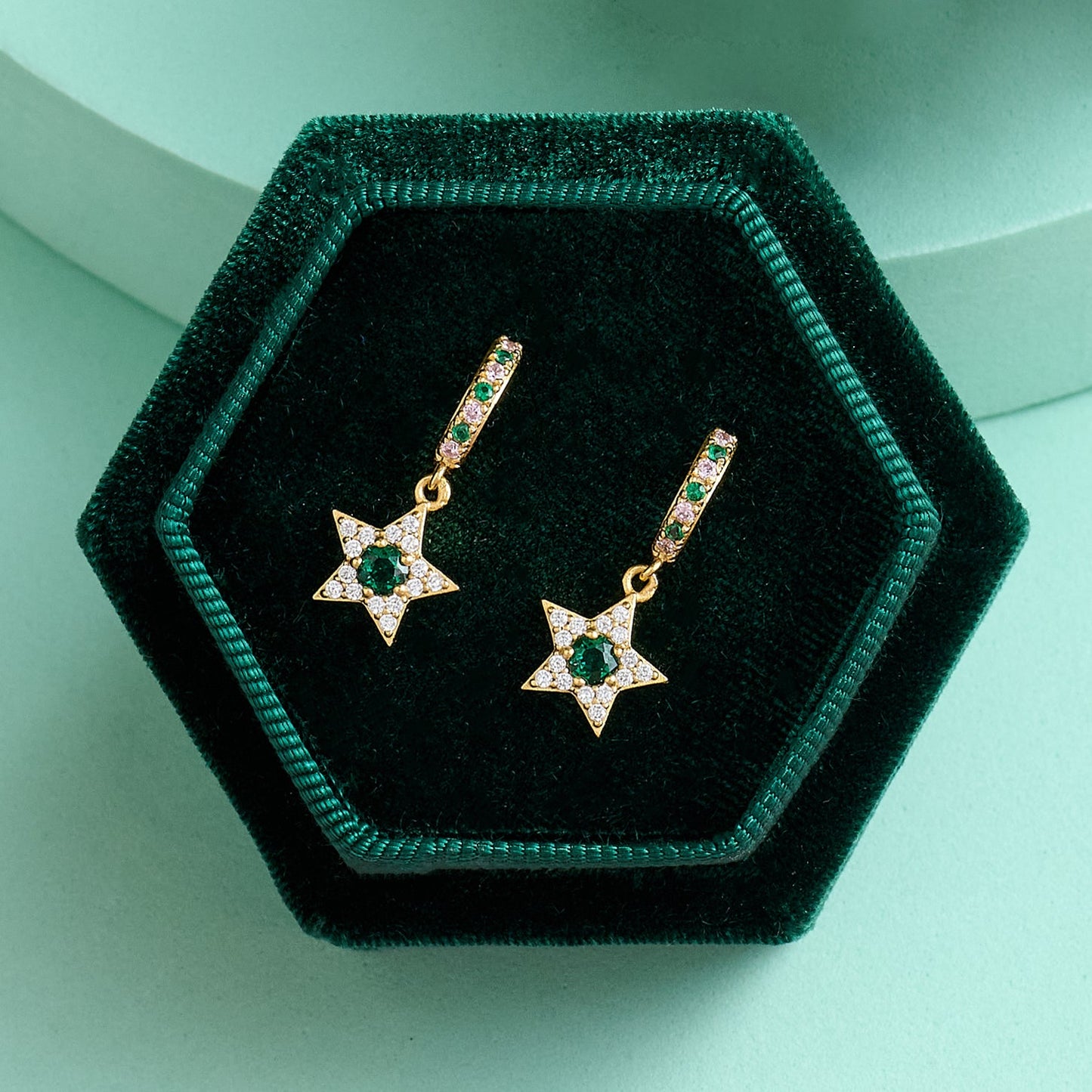 Celeste Mini Star Huggie Hoop Earrings with gold plating, emerald green and clear stones in green velvet box