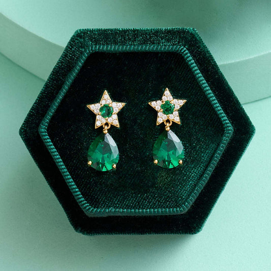 Celeste Mini Star Teardrop stud earrings with emerald green teardrop stones and gold star accents in velvet box
