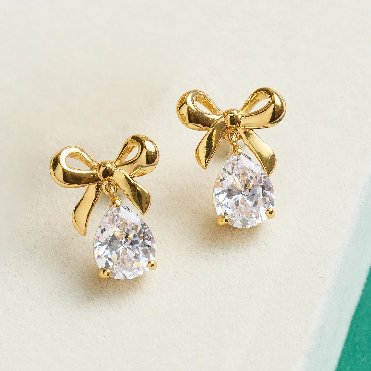Gold bow stud earrings with teardrop clear cubic zirconia from Amelia Bow collection