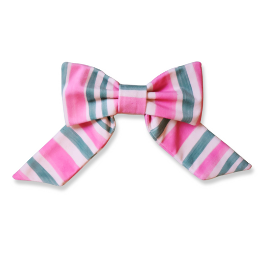 Pink and green striped velvet bow hair accessory with candy stripe print and oversized design